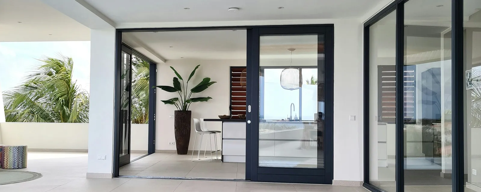 Contemporary home with an inground pool running alongside a covered patio and sliding glass doors